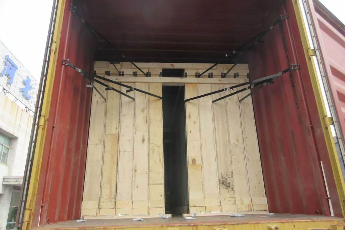 Container interior with wooden crates held by steel bracing